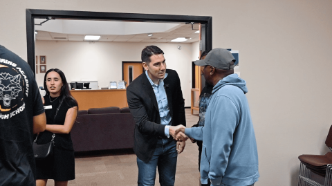 Josh Harder shaking hands with Valley community members
