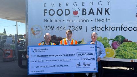 Representative Josh Harder handing large check to Stockton Food Bank
