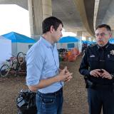 Rep. Harder in front of a row of tents