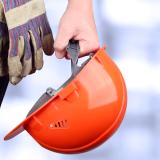 holding a hard hat
