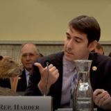 Rep. Harder gestures to a taxidermy nutria named "Nellie" in a House committee hearing